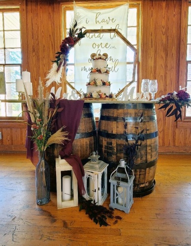 Wedding cake on whiskey barrels with lanterns