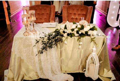 bride and groom reception table with antique velvet chairs